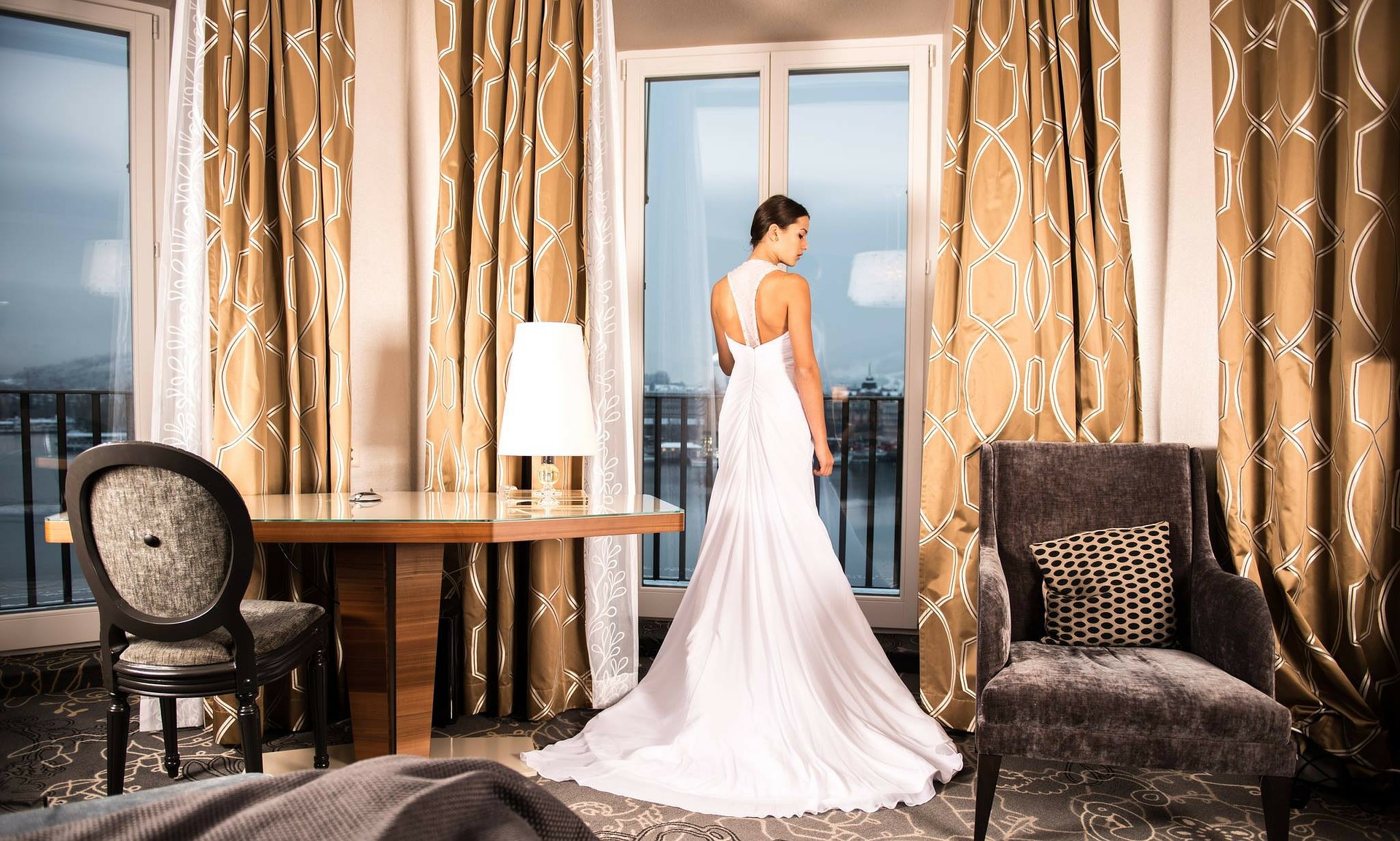 Bride standing in a hotel room with beautiful interior design