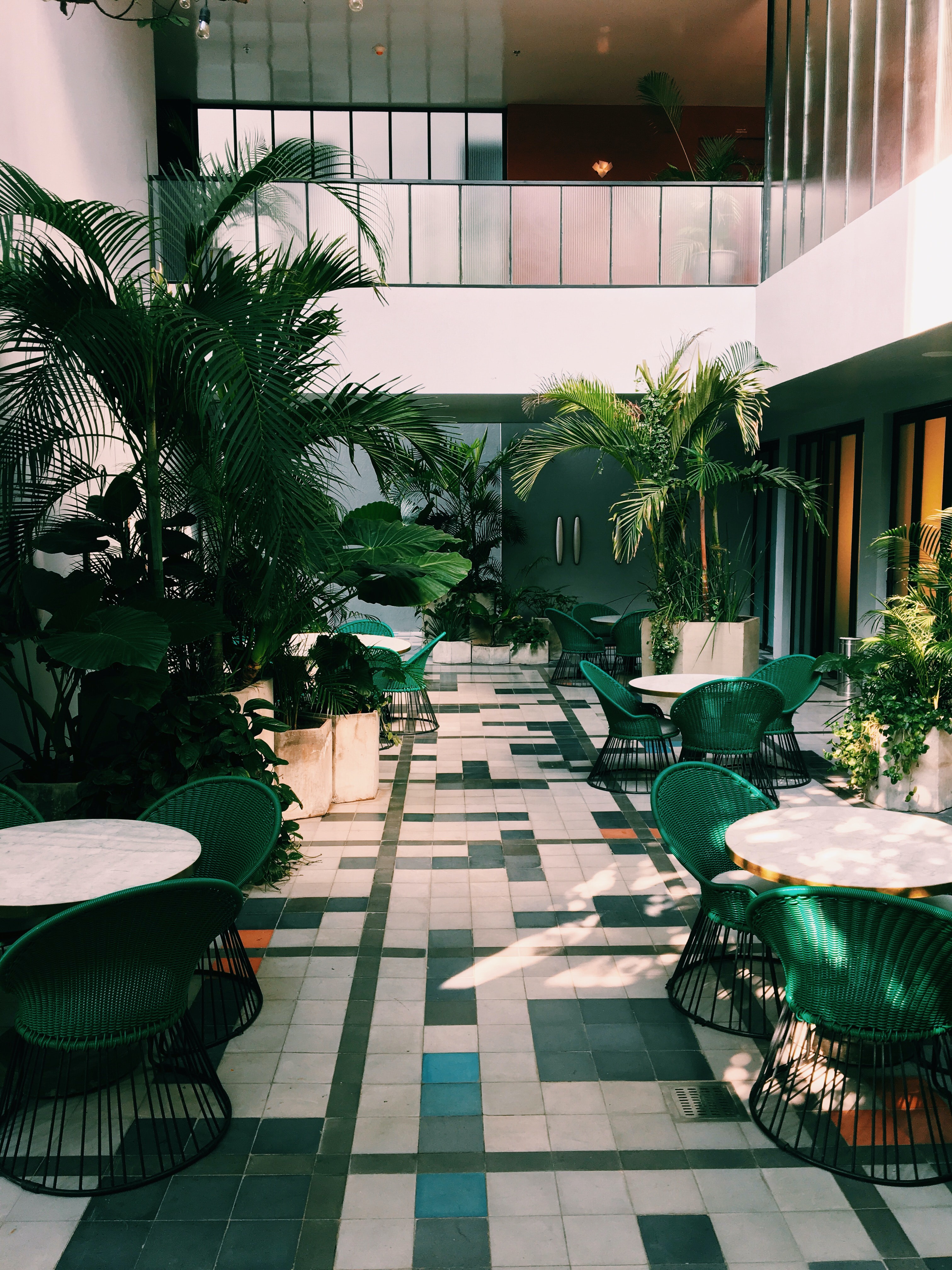 Hotel Lobby with Plants and Green and White Tiles